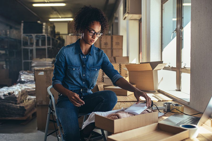 Business Insurance - African American Business Woman Getting Package Ready